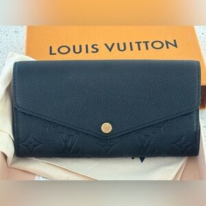 Louis Vuitton Black Women's “Sarah” Wallet with monogram empreinte leather.
